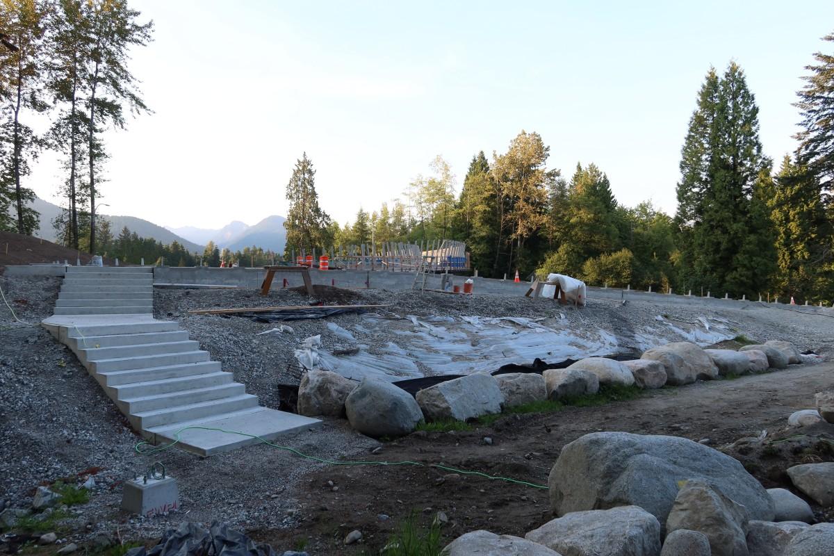 Overpass on the south side. Stairs on the left and a ramp is being built on the right.
