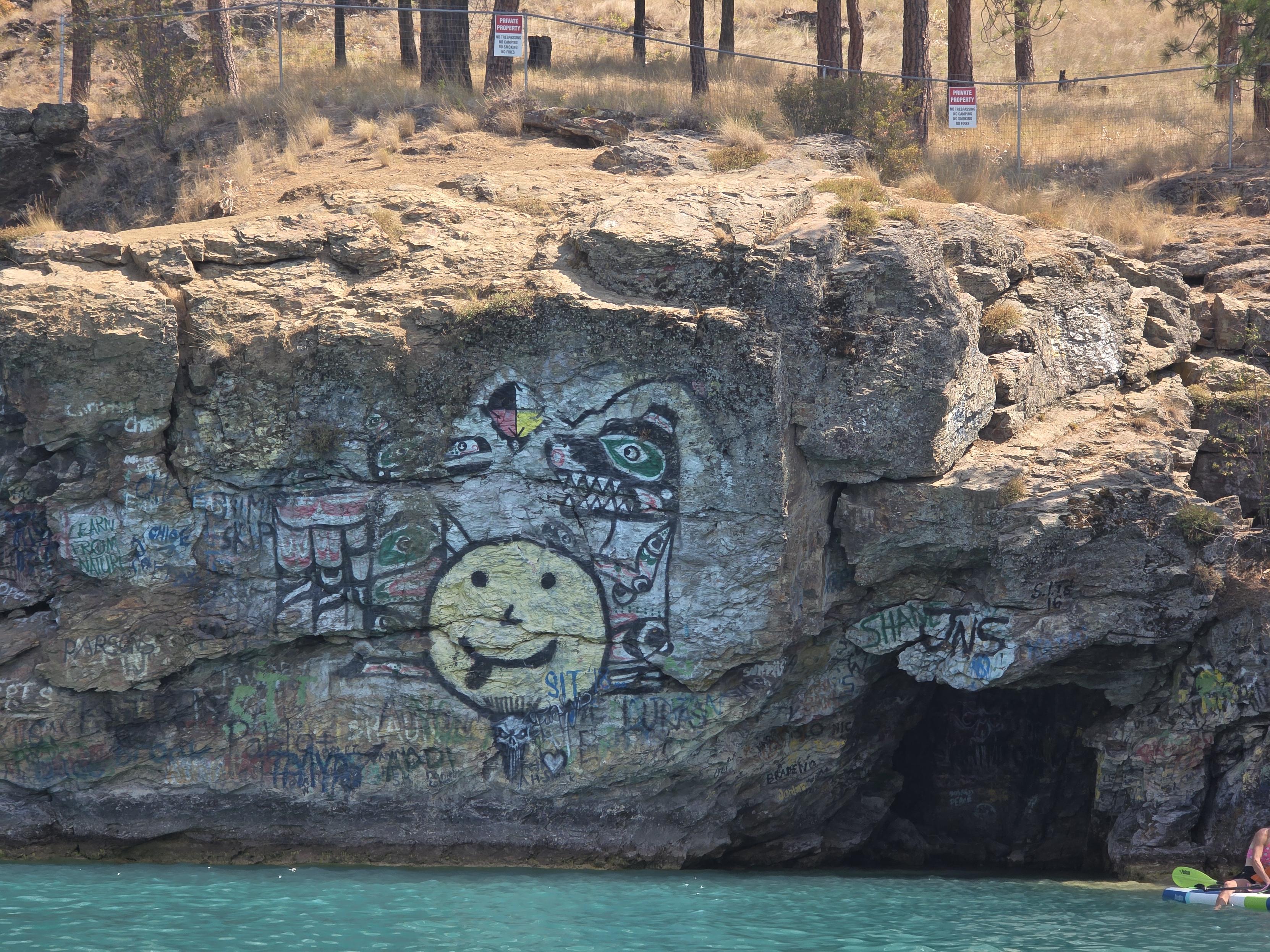 Yellow face painted over Indigenous art.